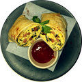 Eggs Benedict breakfast wrap with eggs, bacon, cheese, capsicum and spinach