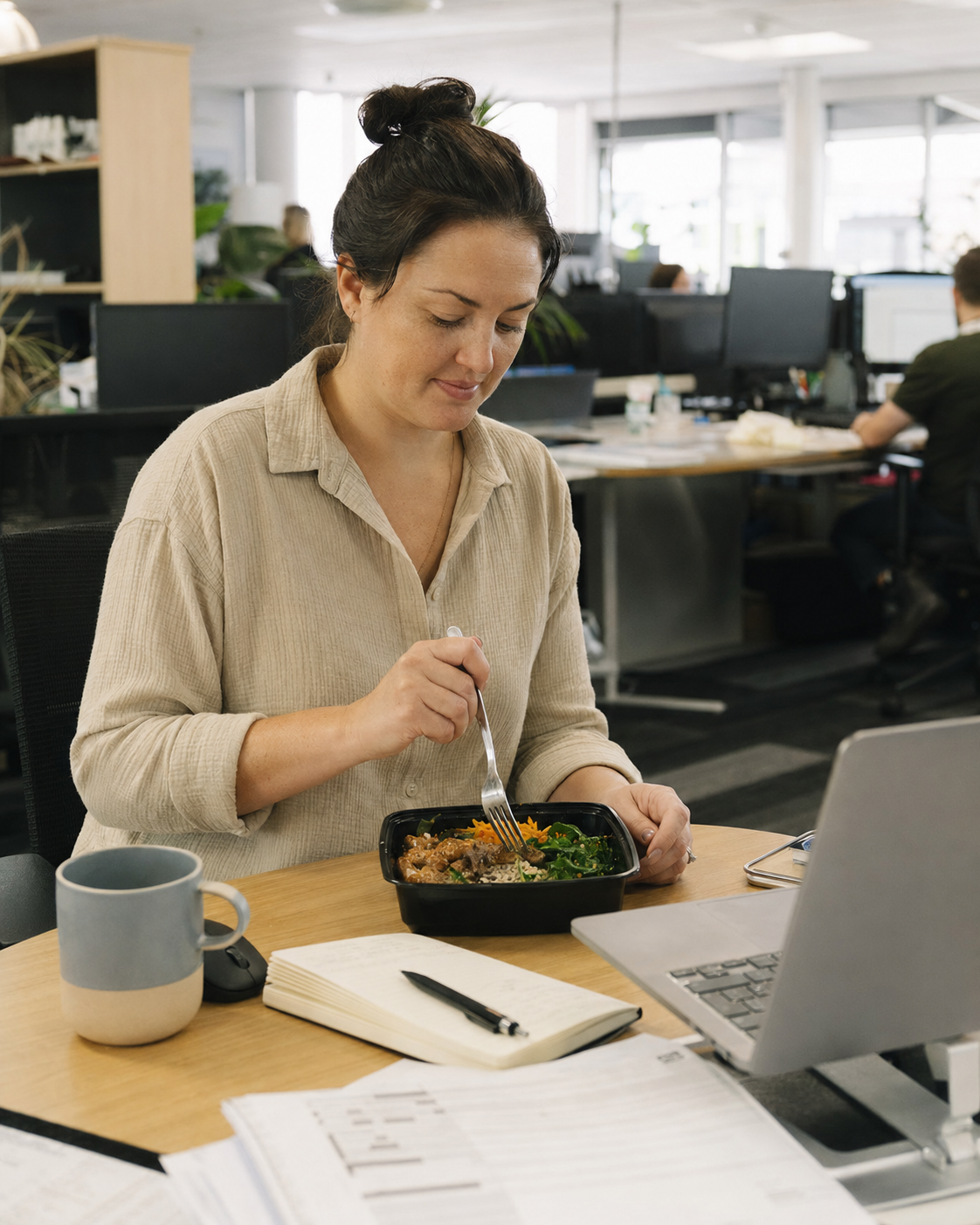 April, who lost 18kg with MealPrep, eating a meal at her desk